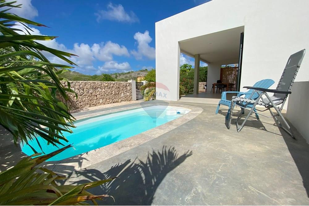 Apartment looking over peaceful nature with a pool